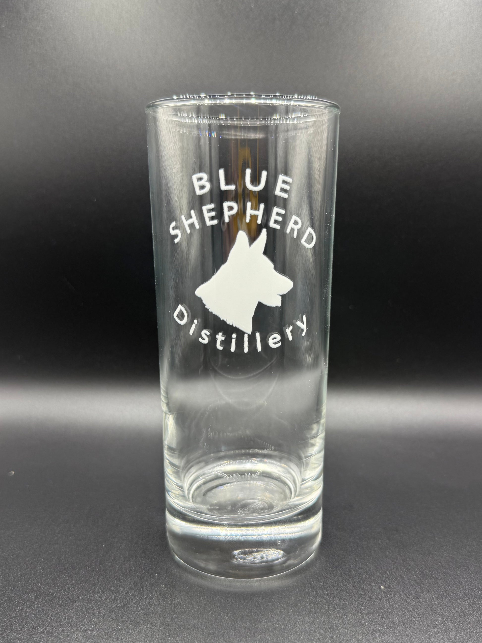 Clear glass bottle with 'Blue Shepherd Distillery' branding on a dark background